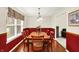 Traditional dining room with wood table, chairs, and natural light from window at 5523 Gainesway Dr, Greenwood, IN 46142