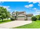 Charming two-story home with a three-car garage, well-manicured lawn, and mature trees at 5523 Gainesway Dr, Greenwood, IN 46142