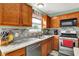 Kitchen with stainless steel appliances, wood cabinets, a marble countertop, and tile backsplash at 5523 Gainesway Dr, Greenwood, IN 46142