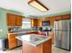 Well-lit kitchen with stainless steel appliances, center island, and a lovely tile backsplash at 5523 Gainesway Dr, Greenwood, IN 46142
