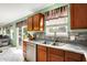 Kitchen with stainless steel appliances, wood cabinets, marble countertops, and sliding glass doors at 5523 Gainesway Dr, Greenwood, IN 46142