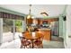 Cozy dining area with wood table adjoins kitchen with stainless steel appliances and access to the outdoor deck at 5523 Gainesway Dr, Greenwood, IN 46142