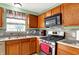 Close-up of a kitchen featuring stainless steel appliances, wood cabinets, and marble countertops at 5523 Gainesway Dr, Greenwood, IN 46142