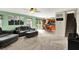 Open-concept living room with gray sofas, a ceiling fan, and a seamless flow to the kitchen and dining area at 5523 Gainesway Dr, Greenwood, IN 46142