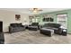 Bright living room with gray sofas, neutral carpet, and large windows offering ample natural light at 5523 Gainesway Dr, Greenwood, IN 46142