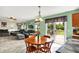 Bright and airy living room with adjacent dining area, featuring sliding glass doors to the outdoor deck at 5523 Gainesway Dr, Greenwood, IN 46142