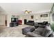 Inviting living room features plush gray furniture, a fireplace, and a view of the adjacent dining area at 5523 Gainesway Dr, Greenwood, IN 46142