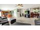 Spacious living area with open layout to kitchen and dining room, carpeted, featuring gray sofas and modern decor at 5523 Gainesway Dr, Greenwood, IN 46142