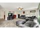 Comfortable living room features neutral colors, modern ceiling fan, and a large window for natural light at 5523 Gainesway Dr, Greenwood, IN 46142