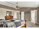 Spacious main bedroom with a ceiling fan, multiple doors, and a view of the attached bathroom at 5523 Gainesway Dr, Greenwood, IN 46142