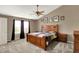 Bedroom with a ceiling fan, natural light from a window, and warm earth tones at 5523 Gainesway Dr, Greenwood, IN 46142