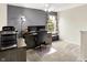 Office space with carpeted floors, a desk with dual monitors, and a grey accent wall at 5523 Gainesway Dr, Greenwood, IN 46142