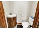 Cozy powder room boasts a pedestal sink and modern toilet, conveniently located for guests at 5523 Gainesway Dr, Greenwood, IN 46142