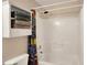 Clean white shower with a colorful shower curtain and built-in shelving for towels at 5523 Gainesway Dr, Greenwood, IN 46142