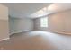 Spacious basement featuring gray carpeting and a bright window allowing natural light at 6039 Chinkapin Dr, Columbus, IN 47201
