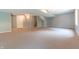 Unfinished basement space with carpet, drop ceiling, and utility access at 6039 Chinkapin Dr, Columbus, IN 47201