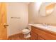 Half bath featuring wood-look floors, neutral walls, granite countertop and modern fixtures at 6039 Chinkapin Dr, Columbus, IN 47201