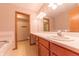 Bathroom with double vanity, cabinets, and large mirror, and attached toilet room at 6039 Chinkapin Dr, Columbus, IN 47201