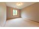 Bright bedroom with large window offering backyard views and a neutral colored carpet at 6039 Chinkapin Dr, Columbus, IN 47201