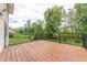 Elevated wooden deck with black metal railing and lush trees at 6039 Chinkapin Dr, Columbus, IN 47201