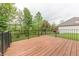 Wooden deck with black metal railing overlooking the yard at 6039 Chinkapin Dr, Columbus, IN 47201