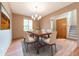 Inviting dining room with wood floors, a modern chandelier, and large windows for natural light at 6039 Chinkapin Dr, Columbus, IN 47201