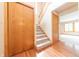 Inviting entryway featuring stairs with wood railing and a coat closet at 6039 Chinkapin Dr, Columbus, IN 47201