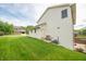 Side view of home showcasing the well-maintained lawn, siding, and landscaping, plus an exterior door at 6039 Chinkapin Dr, Columbus, IN 47201