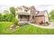 Inviting home with a charming front porch, landscaped garden beds, and a well-manicured lawn at 6039 Chinkapin Dr, Columbus, IN 47201