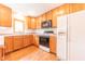 Functional kitchen featuring wooden cabinets, modern appliances, and hardwood floors at 6039 Chinkapin Dr, Columbus, IN 47201