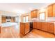 Bright kitchen featuring wooden cabinets, hardwood floors, and an open layout into living space at 6039 Chinkapin Dr, Columbus, IN 47201