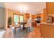 Bright kitchen with wood floors, stainless appliances, wood cabinets, and a dining area with sliding doors at 6039 Chinkapin Dr, Columbus, IN 47201