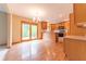 Open-concept kitchen with wood floors, wood cabinets, a breakfast bar, and sliding doors to the outside at 6039 Chinkapin Dr, Columbus, IN 47201