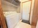 Practical laundry room with washer, dryer, and storage shelves at 6039 Chinkapin Dr, Columbus, IN 47201