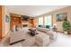 Bright living room with built-in shelving, a cozy fireplace, and plush, neutral-toned furniture at 6039 Chinkapin Dr, Columbus, IN 47201