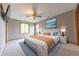 Comfortable primary bedroom with a ceiling fan, two windows, and a stylish bed with a blue rug at 6039 Chinkapin Dr, Columbus, IN 47201
