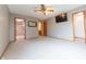 Bright primary bedroom with carpet, a TV, walk-in closet, and views to the attached bathroom at 6039 Chinkapin Dr, Columbus, IN 47201