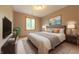 Comfortable primary bedroom with elegant decor, a large window, and neutral tones at 6039 Chinkapin Dr, Columbus, IN 47201