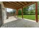 Covered patio showing steps, concrete floors, lawn and garden at 6039 Chinkapin Dr, Columbus, IN 47201