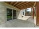 View of concrete patio with sliding glass doors to backyard at 6039 Chinkapin Dr, Columbus, IN 47201