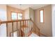 Staircase with wood railing and a view of the entrance foyer and window at 6039 Chinkapin Dr, Columbus, IN 47201