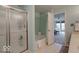 Bathroom with glass shower, soaking tub and doorway to bedroom with seating at 6212 N Woods Edge Dr, McCordsville, IN 46055