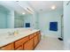Bright bathroom featuring double sinks, a large mirror, and sleek light fixtures at 6212 N Woods Edge Dr, McCordsville, IN 46055