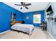 Cozy bedroom with a desk, a ceiling fan and a large window overlooking the lawn at 6212 N Woods Edge Dr, McCordsville, IN 46055
