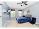 Bedroom features mounted tv, ceiling fan, and a cozy blue comforter at 6212 N Woods Edge Dr, McCordsville, IN 46055