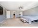 Spacious bedroom with gray walls and carpet features ceiling fan and entry to bathroom at 6212 N Woods Edge Dr, McCordsville, IN 46055