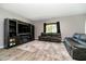 Comfortable living room with cozy furniture, wood floors, entertainment center, and plenty of natural light at 6212 N Woods Edge Dr, McCordsville, IN 46055