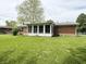 Spacious backyard featuring a sunroom and lush green lawn at 641 Lawndale Dr, Plainfield, IN 46168