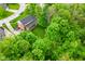 Aerial view showcases the red brick house nestled among trees in a lush green neighborhood at 6567 Kings Ct, Avon, IN 46123