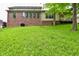 Spacious backyard with brick house exterior and large well-maintained lawn providing ample space for outdoor activities at 6567 Kings Ct, Avon, IN 46123
